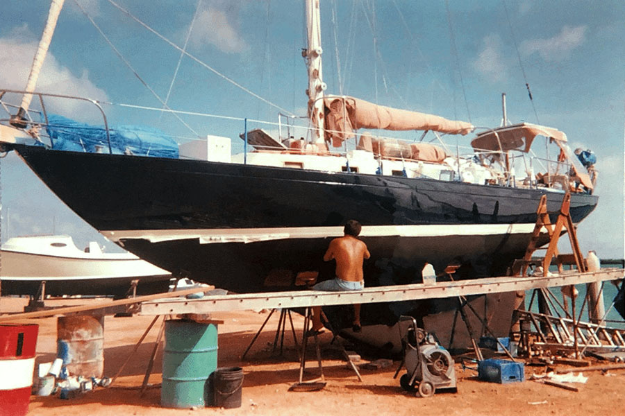 Young Marahlago creator Adrian Nixon working on the boat that took him to the Dominican Republic.