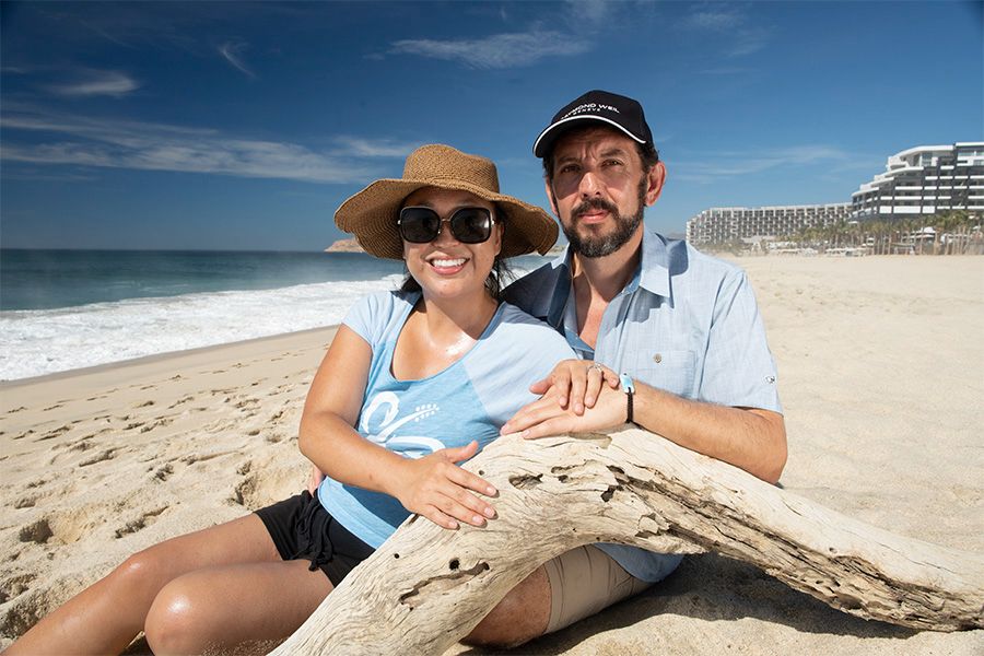 Adrian Nixon sitting on the beach with his wife in the DR, where he discovered the Larimar gemstone.
