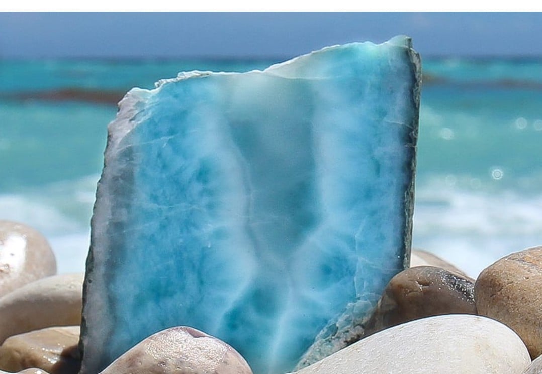 Polished slab of natural Larimar showing soft blue and white cloud-like patterns
