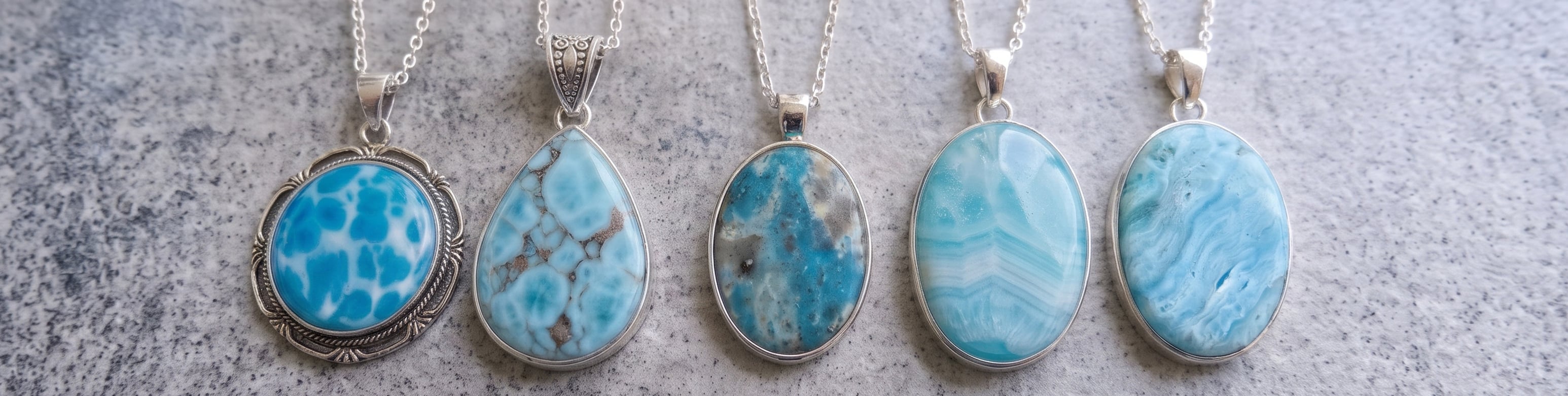 Genuine Larimar pendant next to fake resin, dyed howlite and dyed hemimorphite pendants