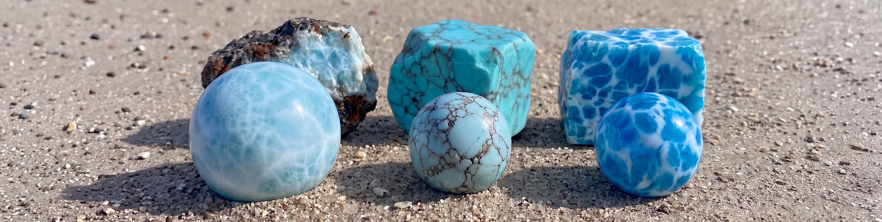 Rough natural Larimar compared with fake Larimar cubes