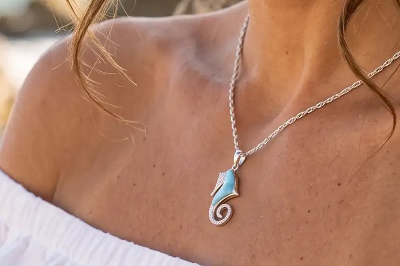 Woman wearing a Larimar pendant necklace