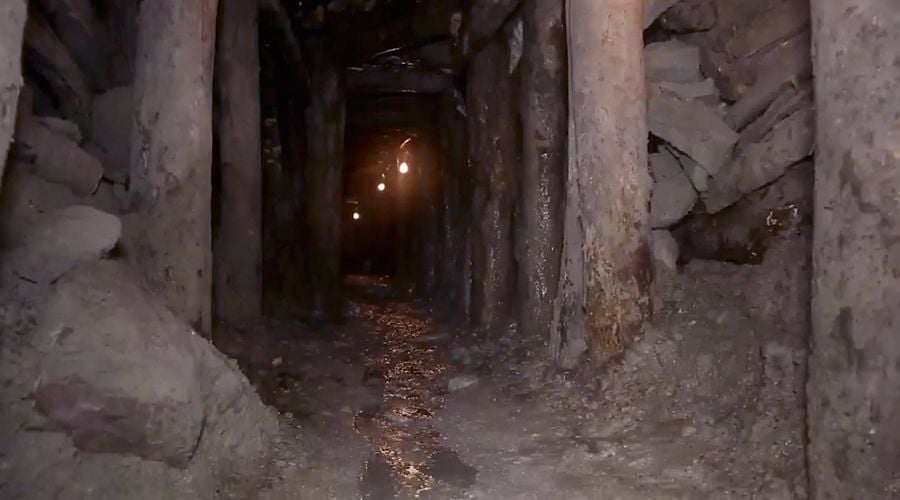 Inside of the Larimar mine. The mine goes further out with lights along the way.