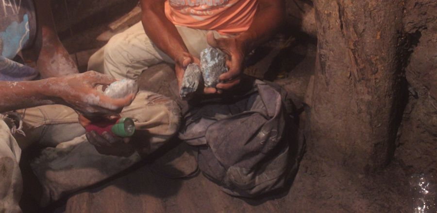 Larimar workers are selecting raw Larimar gemstones they just retrieved from the mine.