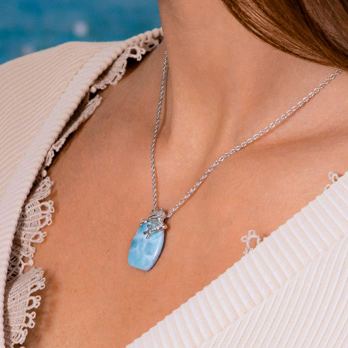 Embrace the charm of Marahlago Jewelry's Larimar Sterling Silver Tree Frog Pendant Necklace. Adorned with a captivating larimar gemstone and white sapphire accents, this silver blue jewelry piece embodies elegance and allure for women.