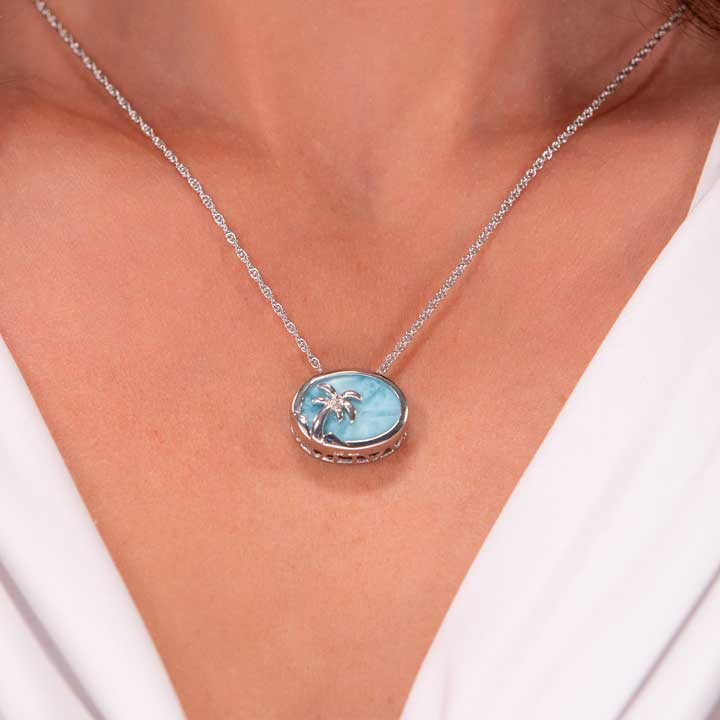 Discover the enchanting Larimar Sterling Silver Palm Tree Pendant Necklace by Marahlago Jewelry. Adorned with a stunning oval silver blue gemstone, this elegant jewelry piece is perfect for women seeking natural beauty and sophistication.